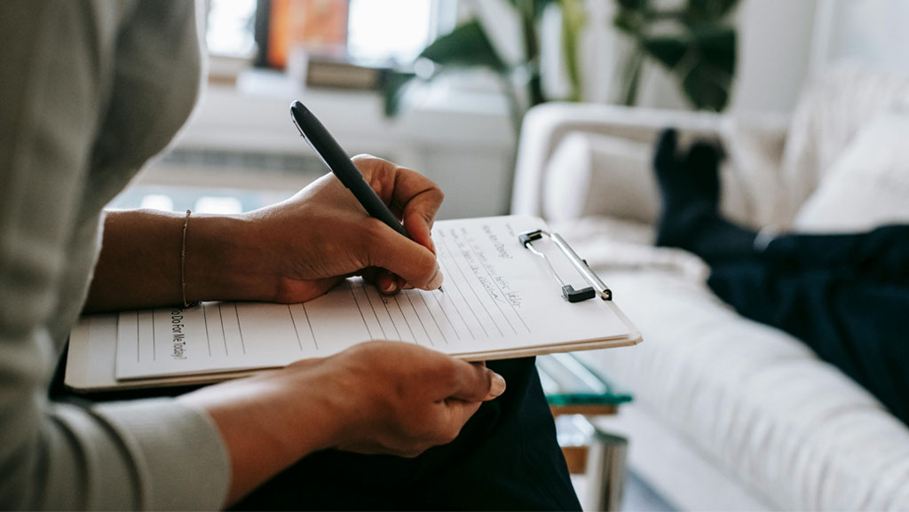 Mental health doctor making notes on medical cannabis for autism treatment, exploring its potential benefits for autism spectrum disorder.