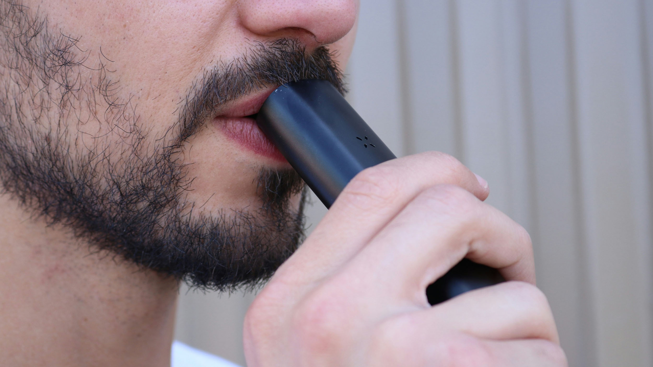 Man using a dry herb vapouriser, demonstrating how a dry herb vapouriser works for medical cannabis use in the UK.