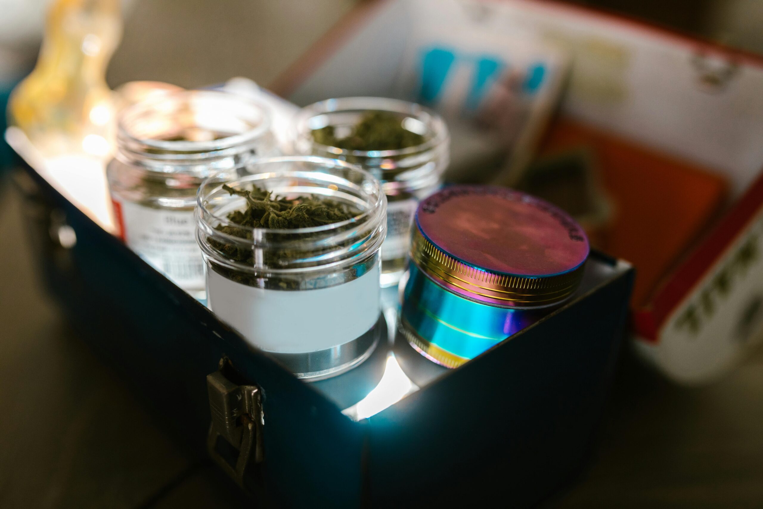 Can cannabis expire? Image showing cannabis flower next to its container, focusing on how long cannabis stays fresh.
