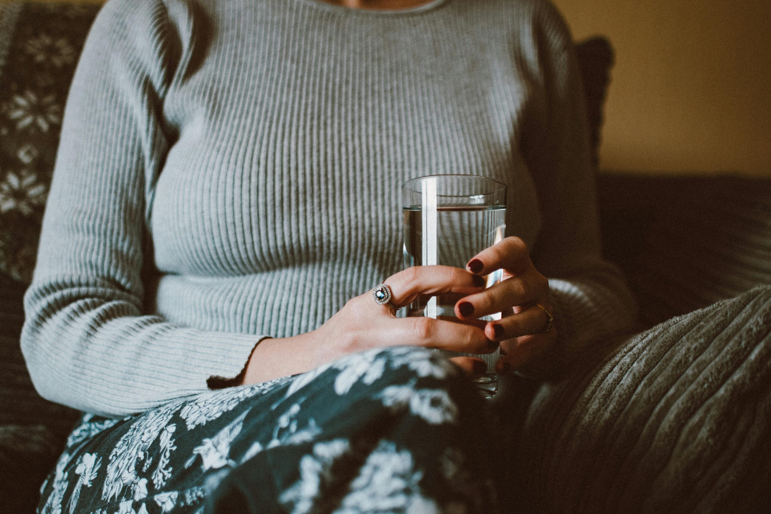 Woman drinking water during fasting while considering can you use cannabis whilst fasting