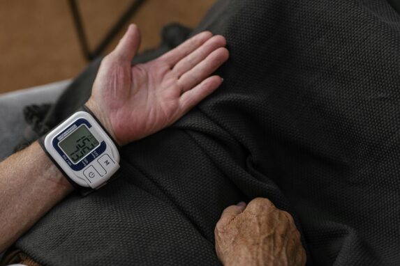 Man using a blood pressure monitor while exploring if cannabis lowers blood pressure