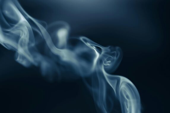 Close-up of smoke curling in the air, symbolising HHC and the discussion around 