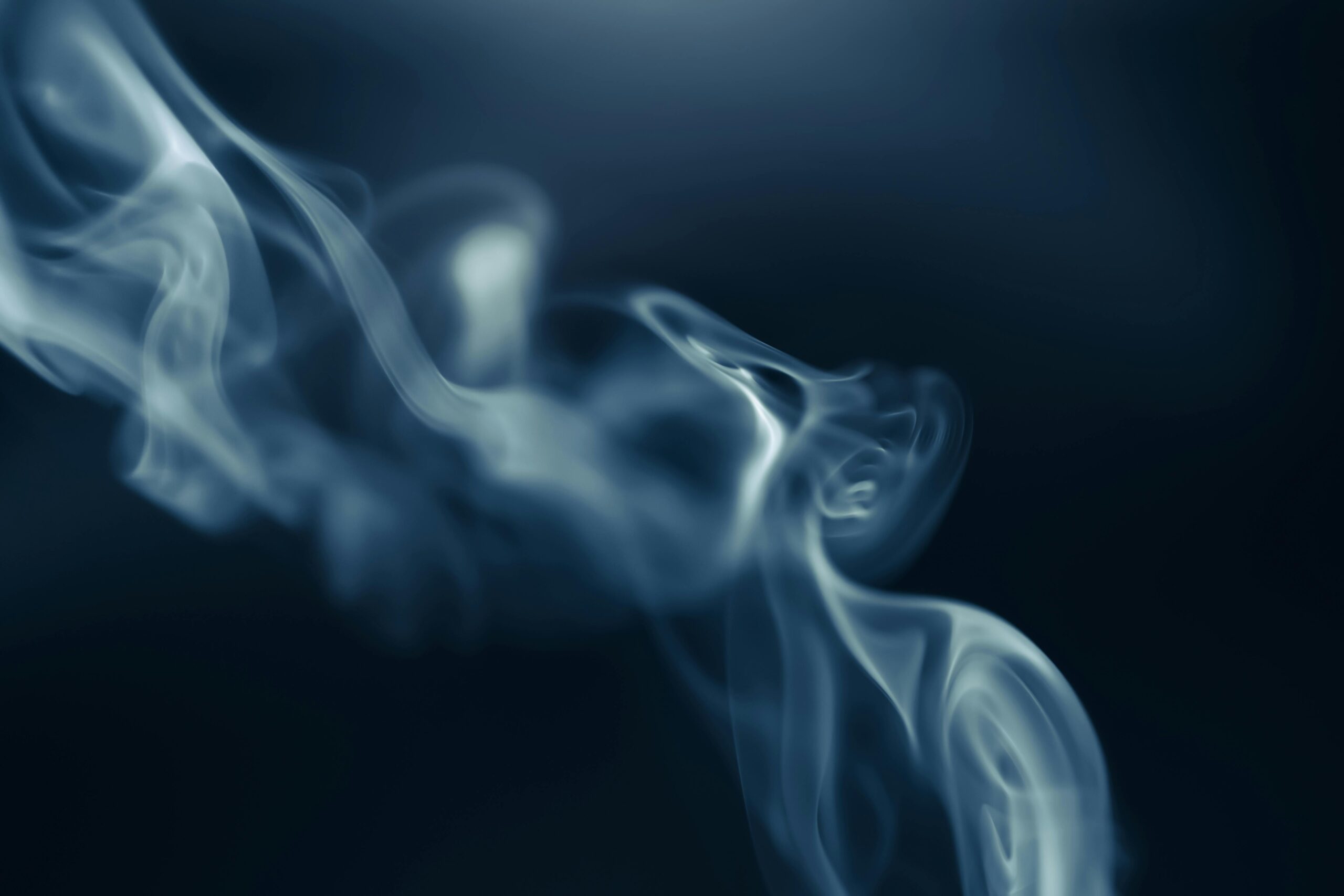 Close-up of smoke curling in the air, symbolising HHC and the discussion around 