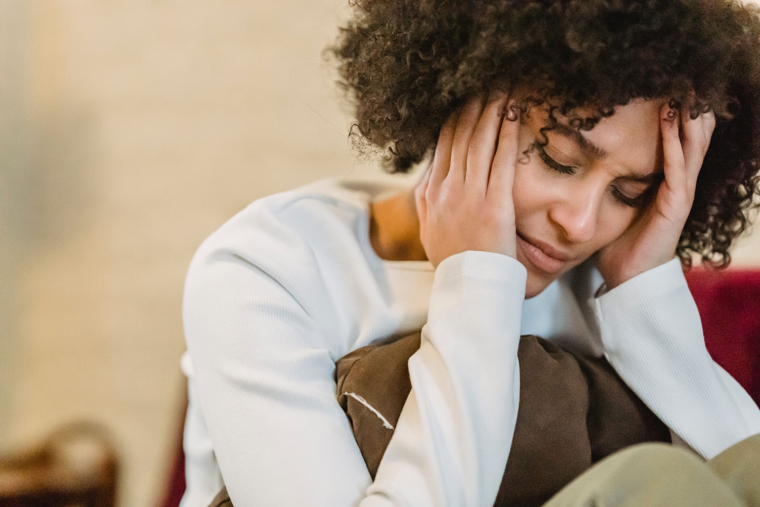 Woman overthinking and feeling stressed, illustrating how to stop overthinking and calm an anxious mind.